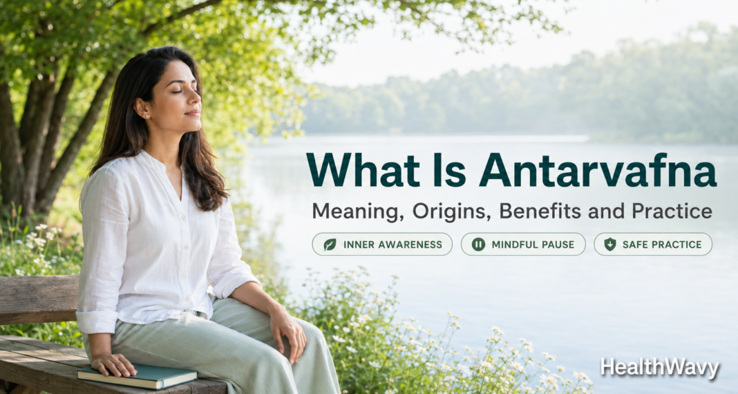 Woman practicing quiet self-reflection beside a peaceful lake, representing Antarvafna and mindfulness.